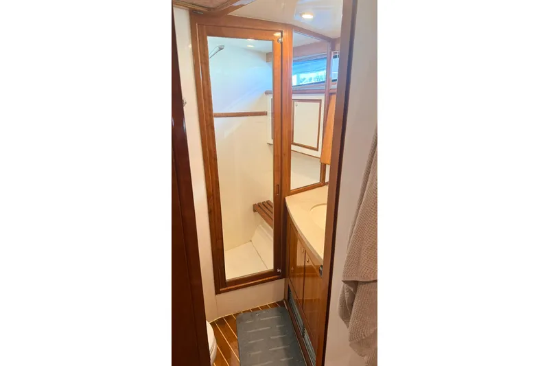 Slide: The Image of Bathroom interior of 2003 Mikelson 50 yacht with wooden accents and shower. - 17