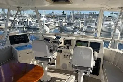 Slide: The Image of Helm of 2003 Mikelson 50 yacht with marina view, featuring dual captain chairs and navigation equipment. - 20