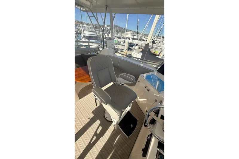 Slide: The Image of Helm station of 2003 Mikelson 50 yacht with captain's chair and marina view. - 21