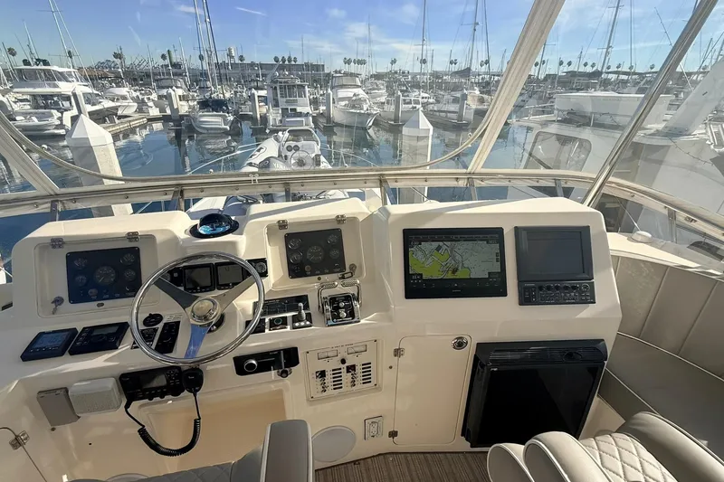 Slide: The Image of Cockpit of 2003 Mikelson 50 yacht with navigation screens and steering wheel, docked at marina. - 24