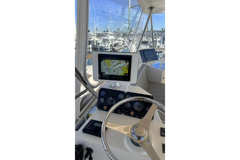 Slide: The Image of Steering console of a 2003 Mikelson 50 yacht with navigation display. - 27