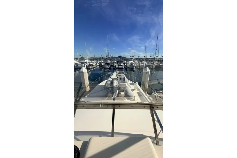 Slide: The Image of 2003 Mikelson 50 yacht docked in a marina under clear blue skies. - 29