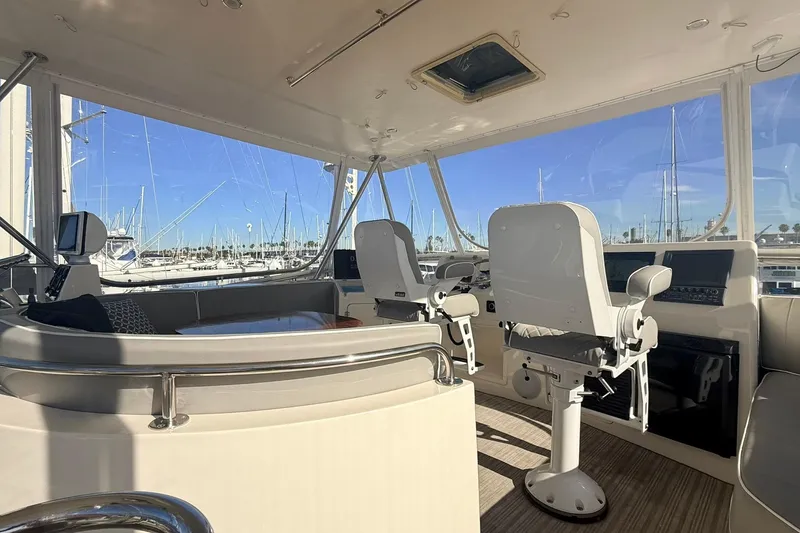 Slide: The Image of Interior of 2003 Mikelson 50 yacht with helm chairs and marina view. - 33