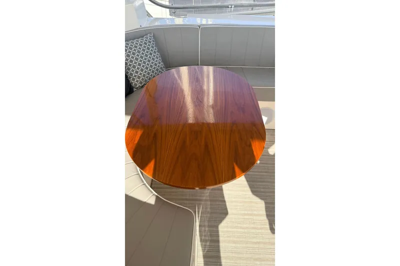 Slide: The Image of Luxurious wooden table on 2003 Mikelson 50 yacht with cushioned seating. - 34