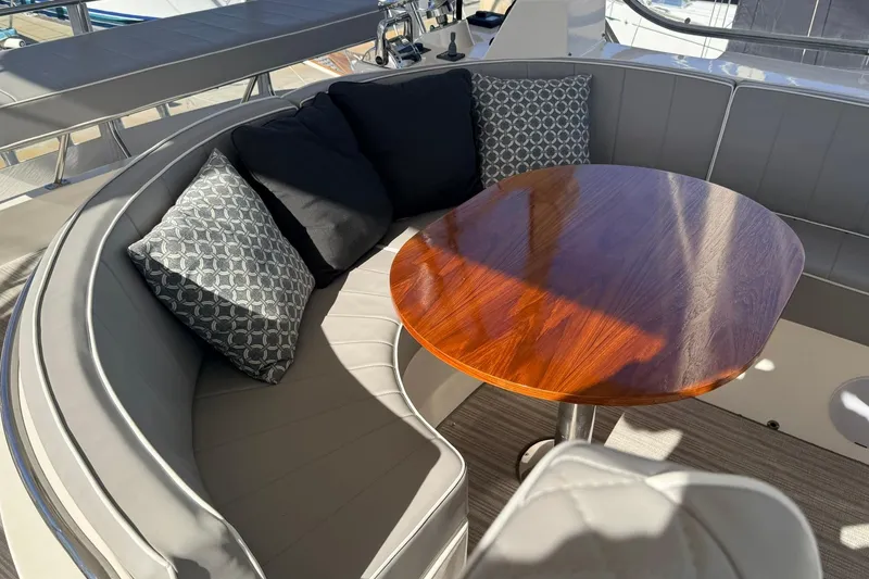 Slide: The Image of Luxurious seating area on a 2003 Mikelson 50 yacht with elegant cushions and wooden table. - 35