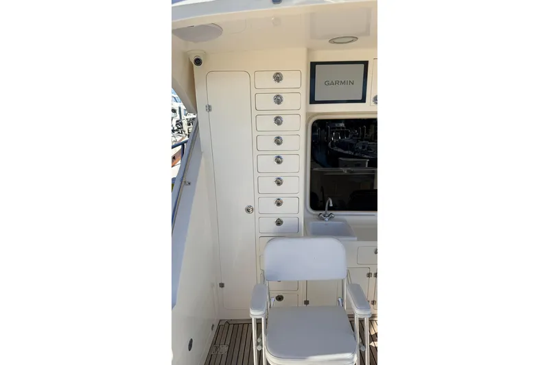 Slide: The Image of Interior of 2003 Mikelson 50 yacht with storage, Garmin display, and seating. - 36