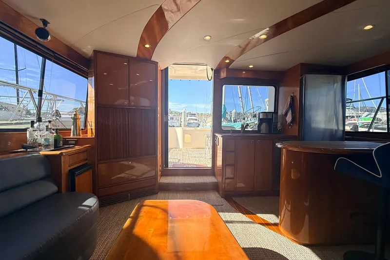 Slide: The Image of Luxurious interior of a 2003 Mikelson 50 yacht with elegant wood finishes and marina view. - 5