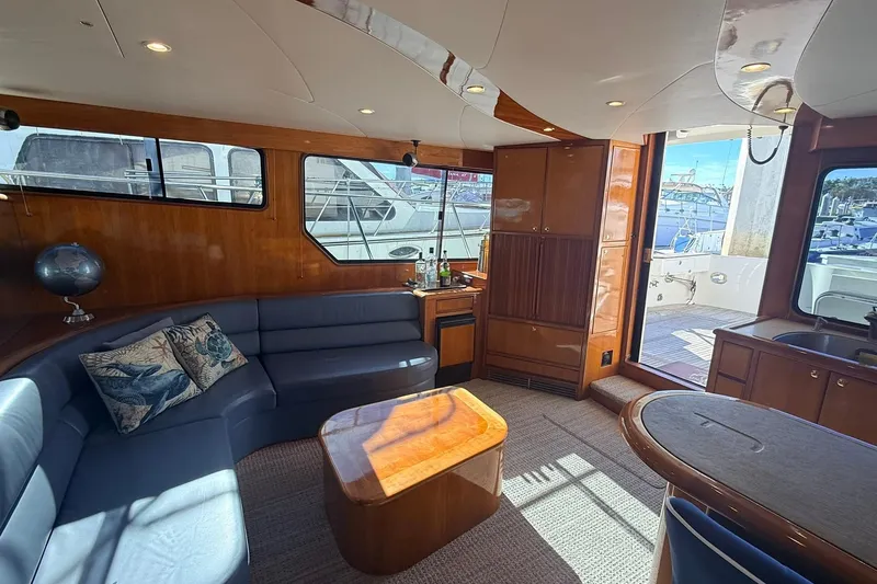 Slide: The Image of Luxurious interior of a 2003 Mikelson 50 yacht with elegant seating and wooden finishes. - 6