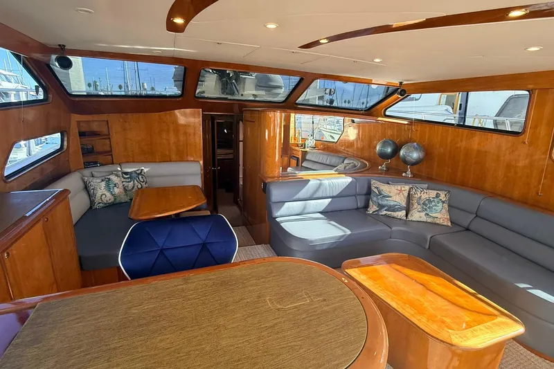 Slide: The Image of Luxurious interior of a 2003 Mikelson 50 yacht with elegant wood finishes and plush seating. - 7