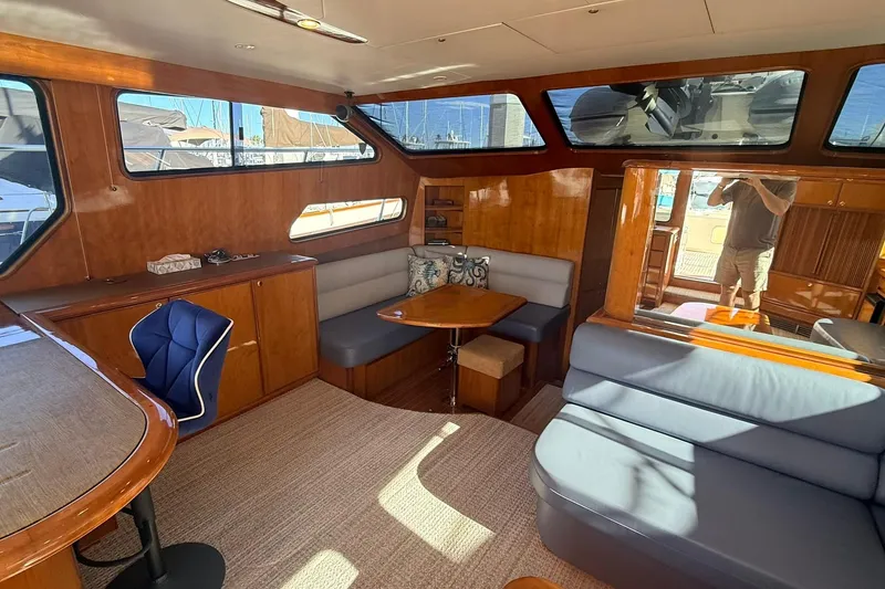 Slide: The Image of Luxurious interior of a 2003 Mikelson 50 yacht with elegant wood finishes and seating. - 8