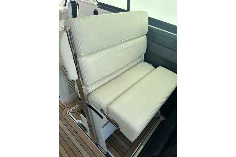 Slide: The Image of White leather seat on 2015 Monterey 360 Sport Coupe boat, featuring sleek design and comfort. - 10