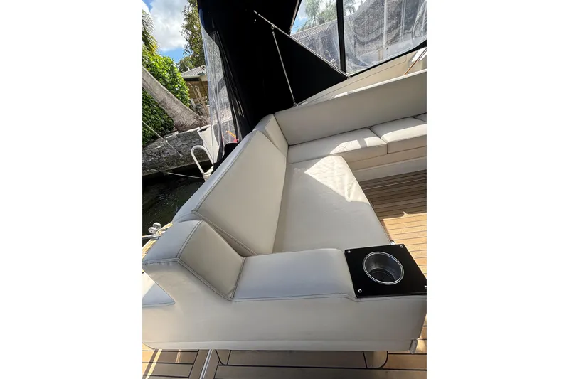 Slide: The Image of Luxurious seating on 2015 Monterey 360 Sport Coupe yacht with cup holder and sleek design. - 11