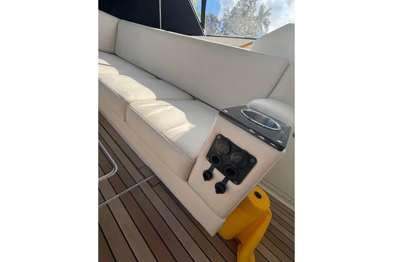 Slide: The Image of Luxurious seating on 2015 Monterey 360 Sport Coupe yacht with cup holder and controls. - 13