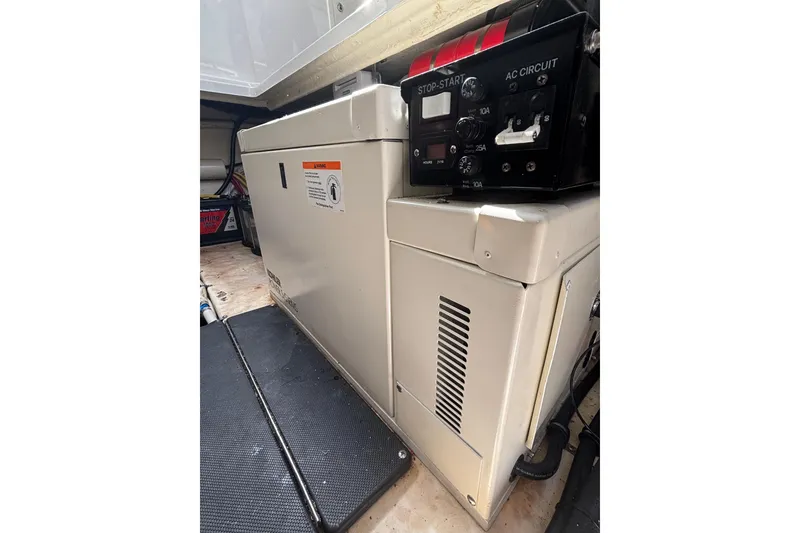 Slide: The Image of Engine compartment of a 2015 Monterey 360 Sport Coupe with control panel and generator. - 22