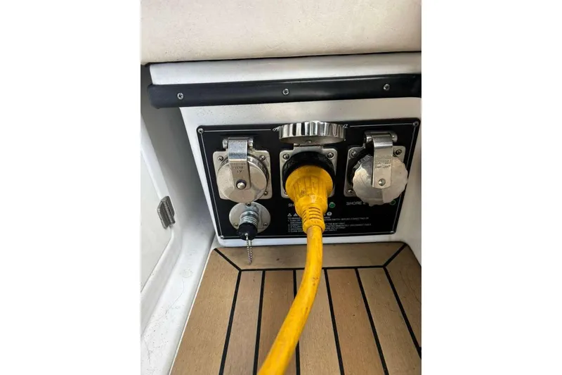 Slide: The Image of Power connection panel on a 2015 Monterey 360 Sport Coupe boat with yellow cable. - 23