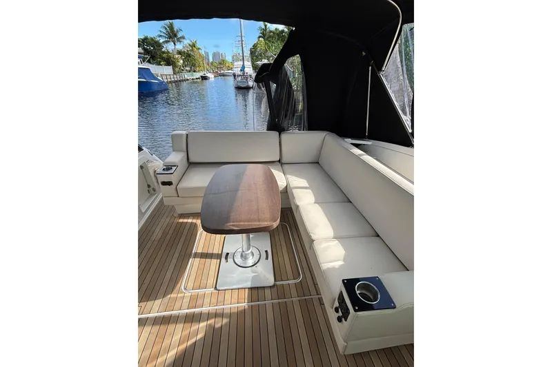 Slide: The Image of 2015 Monterey 360 Sport Coupe interior with elegant seating and wooden table on a sunny day. - 6