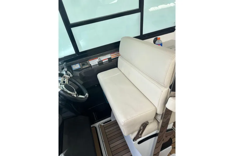 Slide: The Image of 2015 Monterey 360 Sport Coupe helm with white leather seat and steering wheel. - 9