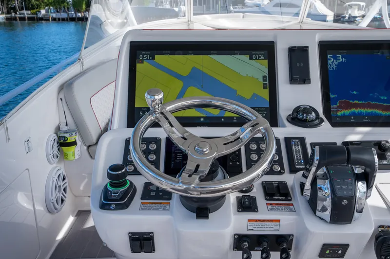 Slide: The Image of Helm of 2022 Intrepid 409 Valor boat with advanced navigation displays and controls. - 22