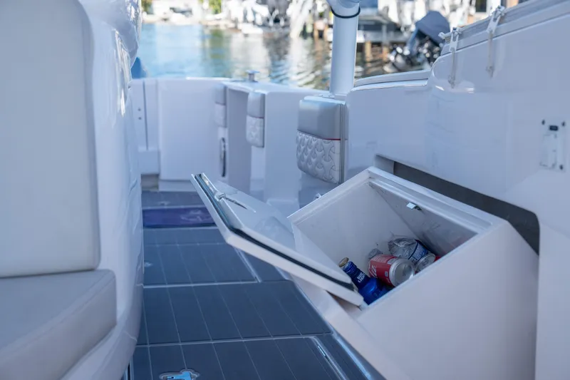 Slide: The Image of 2022 Intrepid 409 Valor boat with open cooler, dockside view. - 30