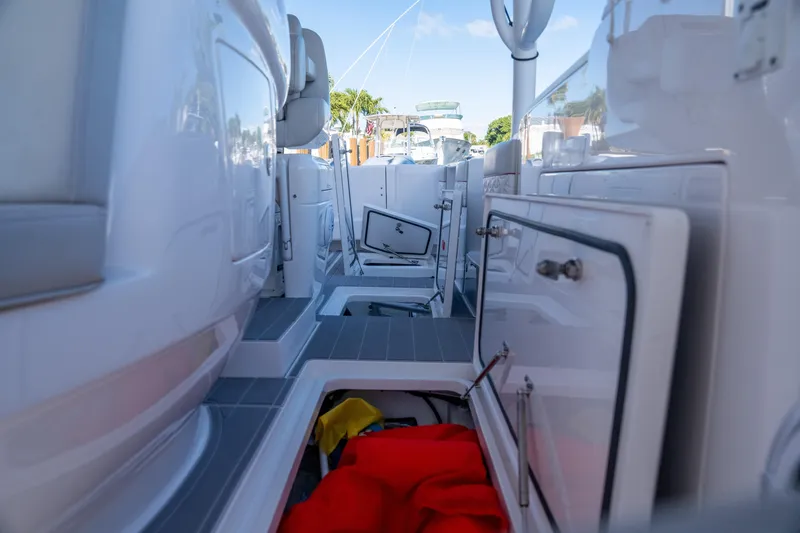 Slide: The Image of 2022 Intrepid 409 Valor boat interior with open storage compartments and visible equipment. - 31