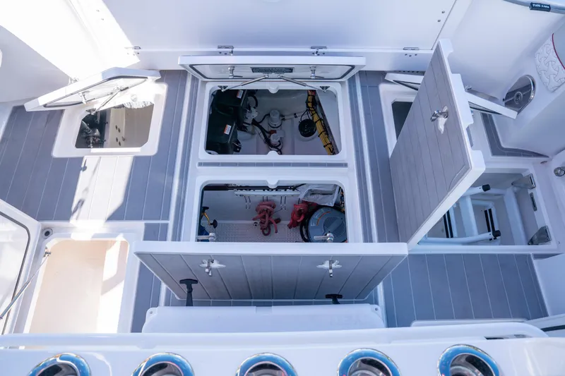 Slide: The Image of 2022 Intrepid 409 Valor boat interior with open storage compartments and equipment. - 32