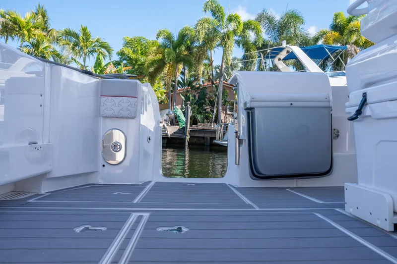 Slide: The Image of 2022 Intrepid 409 Valor boat deck with palm trees in background. - 33