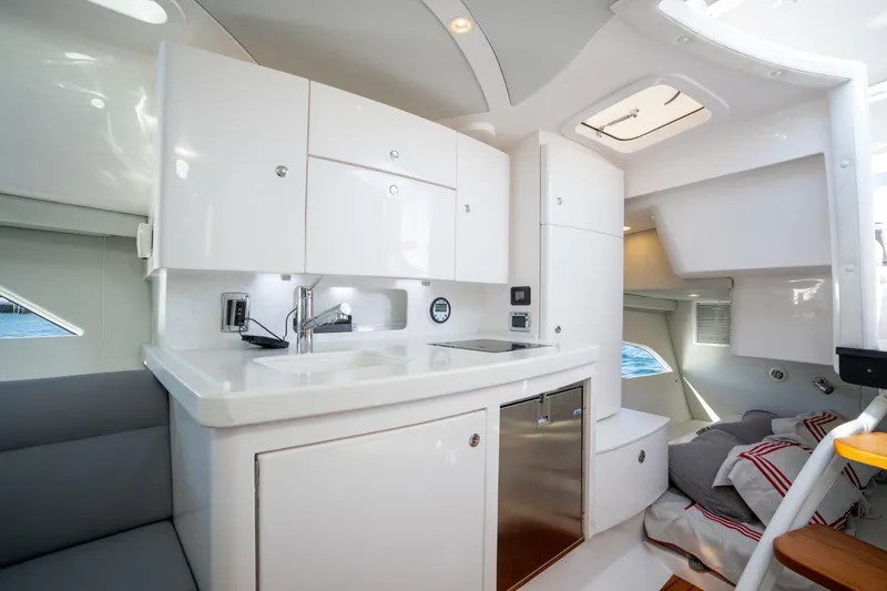 Slide: The Image of Luxurious interior of 2022 Intrepid 409 Valor yacht featuring modern kitchen and cozy sleeping area. - 38