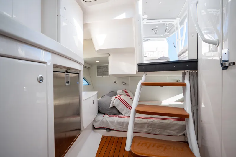 Slide: The Image of Interior of 2022 Intrepid 409 Valor yacht with cozy bed and wooden steps. - 40