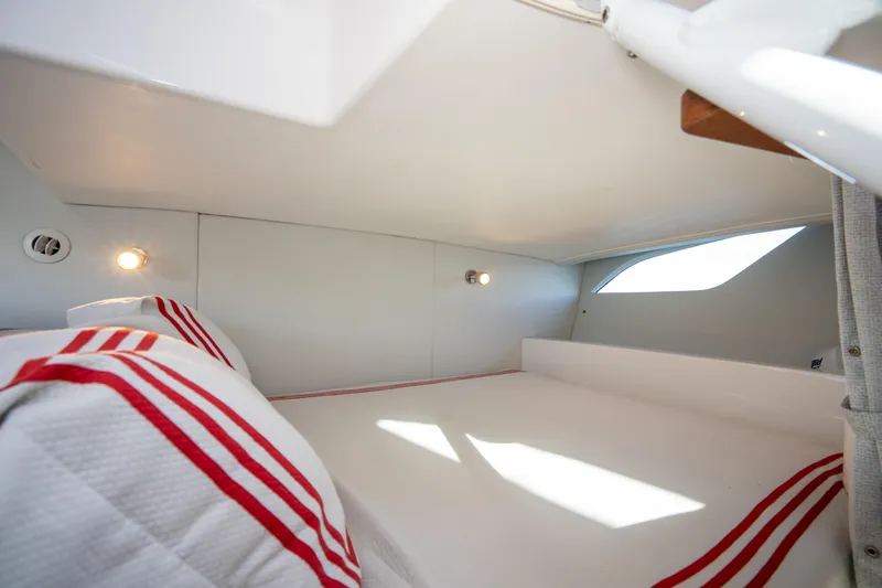 Slide: The Image of Cozy cabin interior of 2022 Intrepid 409 Valor with striped bedding and soft lighting. - 41