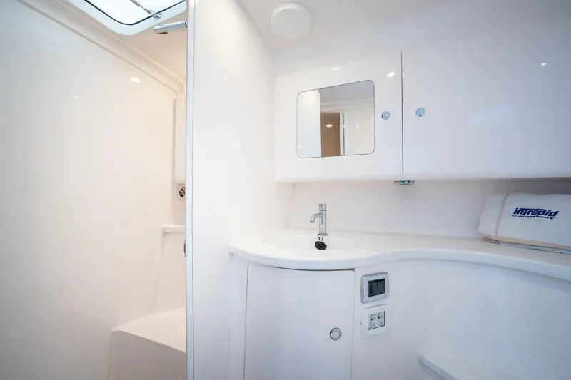 Slide: The Image of Luxurious bathroom interior of 2022 Intrepid 409 Valor boat, featuring sleek white design. - 42
