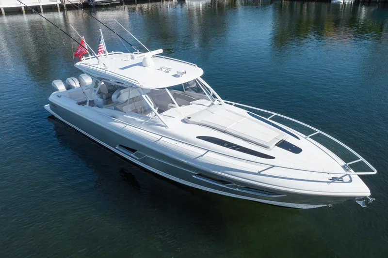 Slide: The Image of 2022 Intrepid 409 Valor boat on calm water, showcasing sleek design and modern features. - 6
