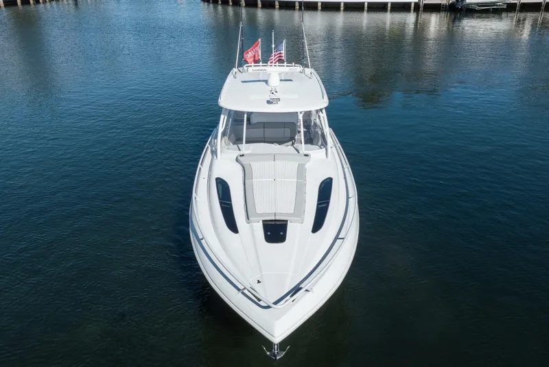 Slide: The Image of 2022 Intrepid 409 Valor boat on calm water, front view. - 8