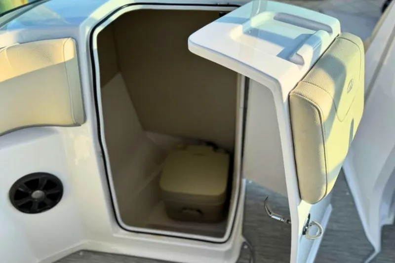 Slide: The Image of 2019 Regal 23 OBX boat interior with open storage compartment and speaker. - 14