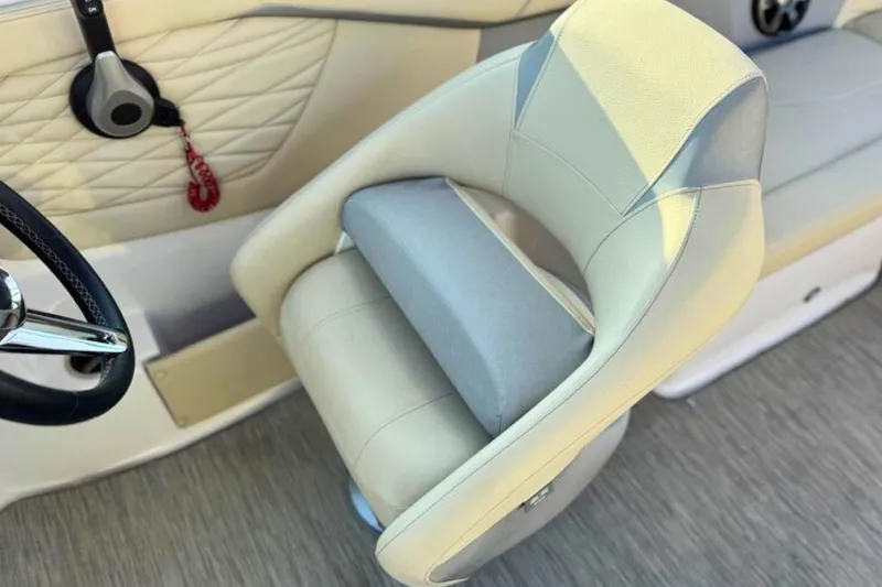 Slide: The Image of 2019 Regal 23 OBX boat interior with beige seating and steering wheel. - 16