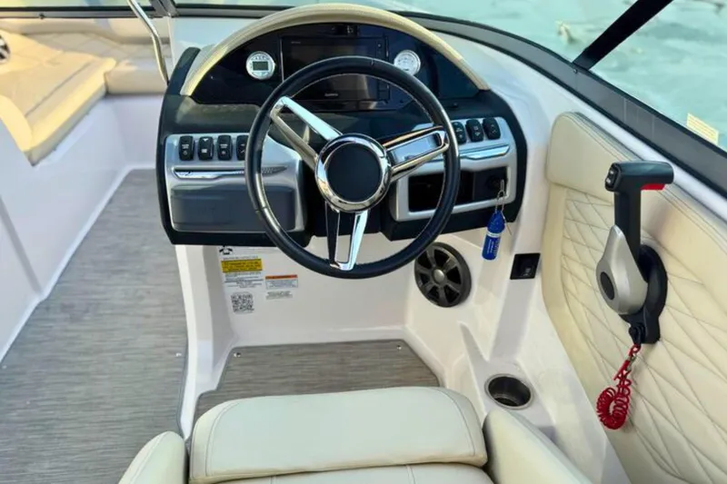Slide: The Image of 2019 Regal 23 OBX boat cockpit with steering wheel and control panel. - 17