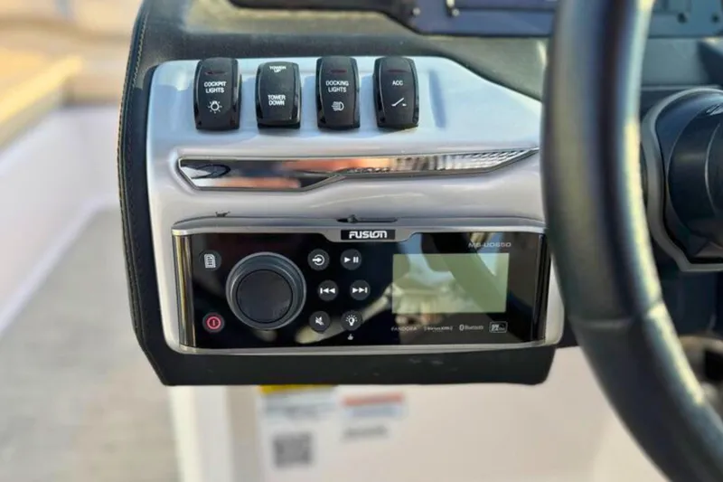 Slide: The Image of Control panel of 2019 Regal 23 OBX boat with Fusion audio system and switches. - 19