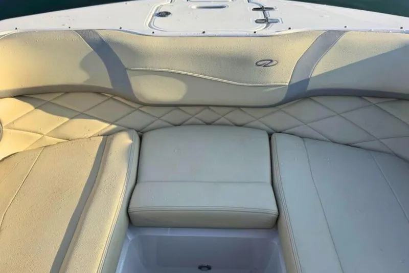 Slide: The Image of 2019 Regal 23 OBX boat interior with beige cushioned seating and diamond stitching. - 24