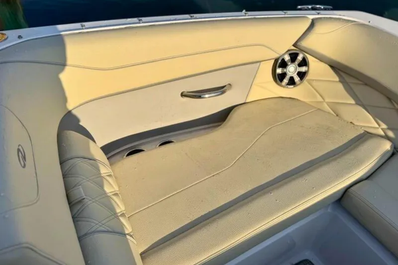 Slide: The Image of 2019 Regal 23 OBX boat interior with beige seating and speaker detail. - 26