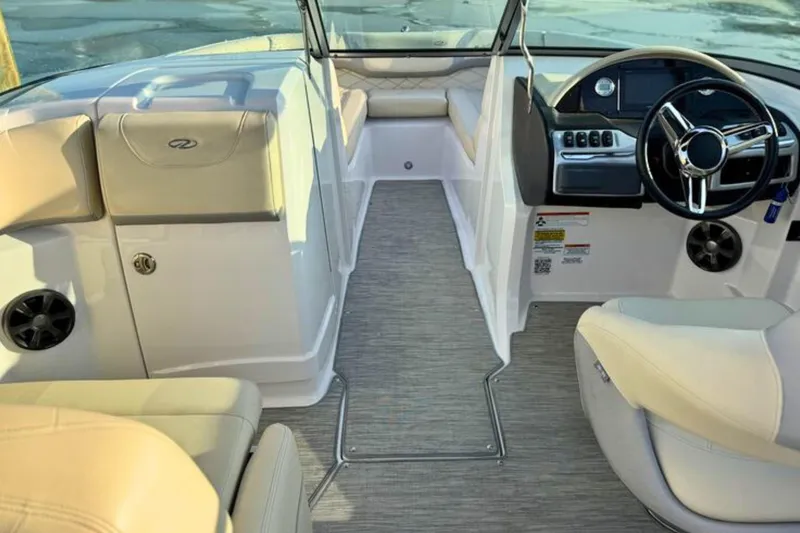 Slide: The Image of 2019 Regal 23 OBX boat interior with steering wheel and seating. - 9