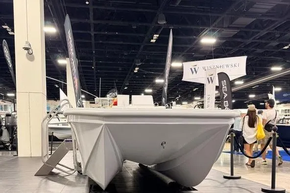Slide: The Image of 2026 American Custom Catamarans 17 displayed at a boat show, front view. - 3