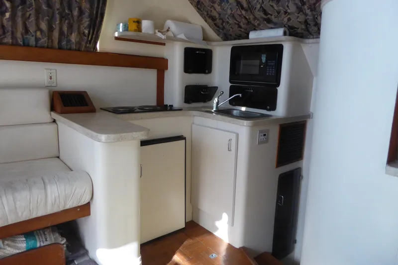 Slide: The Image of Interior of 1996 Luhrs 320 Tournament boat with kitchenette and seating area. - 10