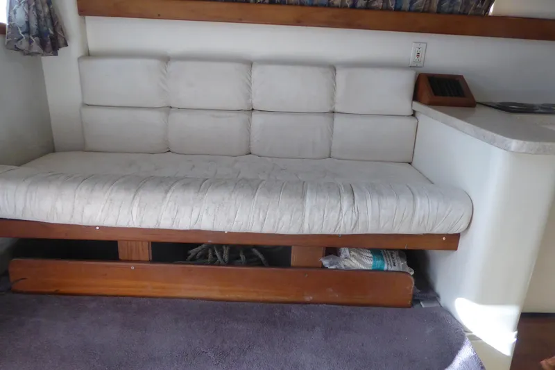 Slide: The Image of 1996 Luhrs 320 Tournament interior with cushioned seating and wooden accents. - 11