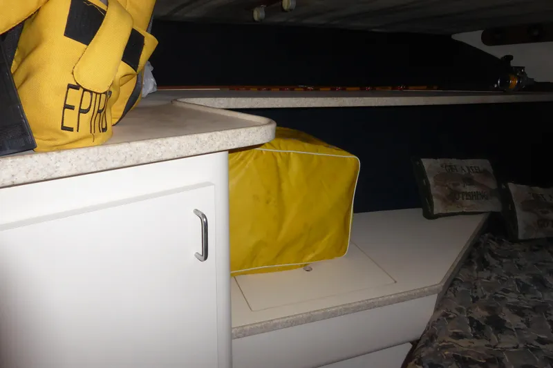 Slide: The Image of 1996 Luhrs 320 Tournament cabin interior with safety gear and storage. - 15