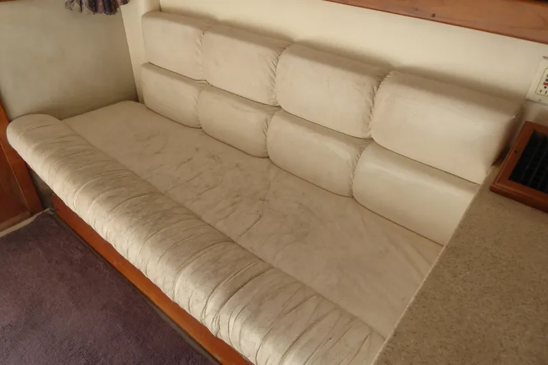 Slide: The Image of 1996 Luhrs 320 Tournament boat interior with beige cushioned seating. - 17