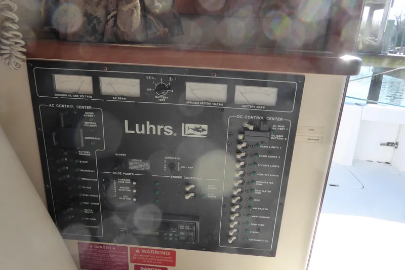 Slide: The Image of Control panel of a 1996 Luhrs 320 Tournament boat, featuring AC and DC systems. - 19