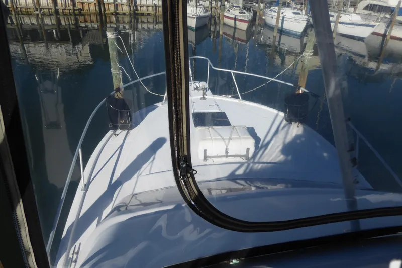 Slide: The Image of 1996 Luhrs 320 Tournament boat docked in a marina, viewed from the helm. - 2