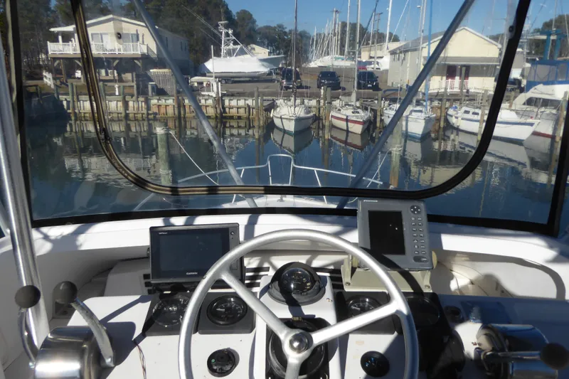 Slide: The Image of Helm view of 1996 Luhrs 320 Tournament boat docked at marina. - 3
