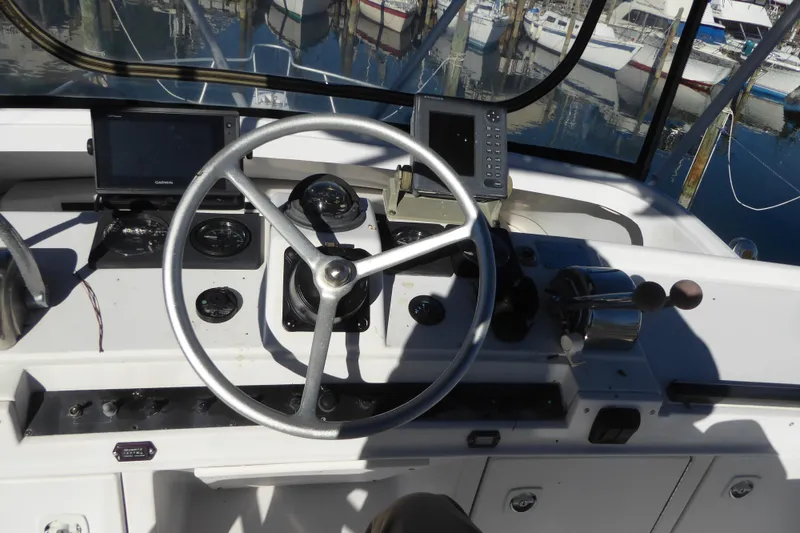 Slide: The Image of 1996 Luhrs 320 Tournament boat helm with steering wheel and navigation equipment. - 4