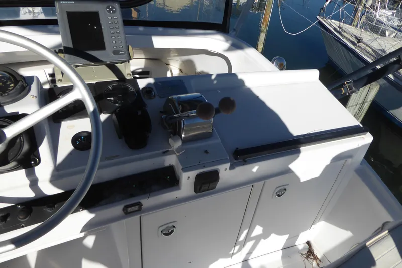 Slide: The Image of 1996 Luhrs 320 Tournament boat helm with steering wheel and navigation equipment. - 5