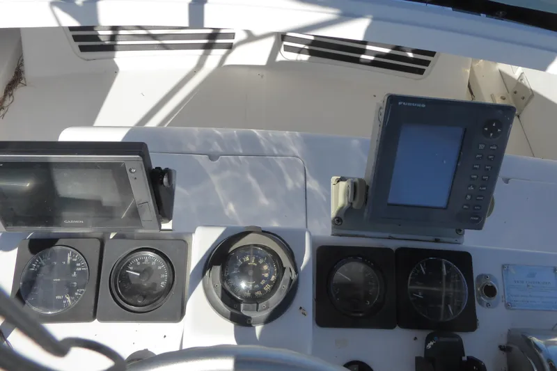 Slide: The Image of 1996 Luhrs 320 Tournament boat dashboard with navigation instruments and gauges. - 6